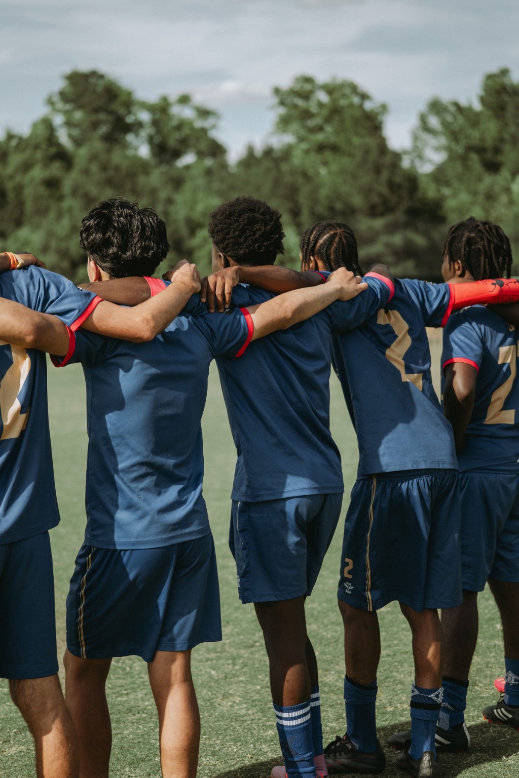 Phantom FC players standing shoulder to shoulder in a huddle